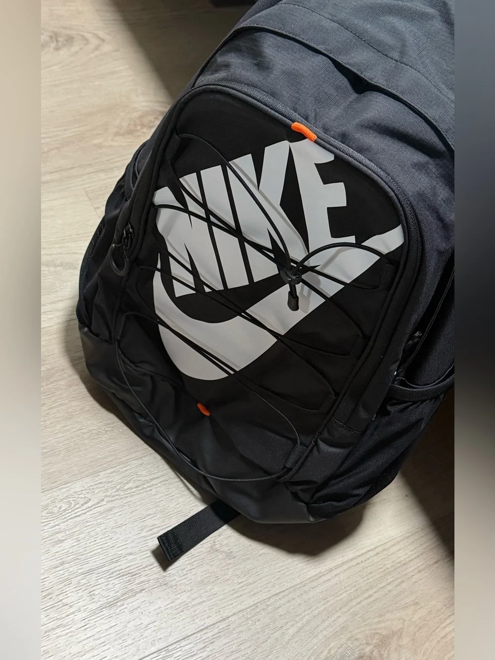 Nike Black Backpack with White Swoosh and Orange Accents